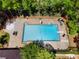 Aerial view of a community pool with lounge chairs, surrounded by lush landscaping at 480 Springs End Ne Ln, Marietta, GA 30068