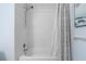 Clean shower with textured white tiles, handheld shower head, and a patterned curtain at 480 Springs End Ne Ln, Marietta, GA 30068