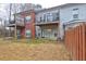 Exterior shot of back of home and backyard with a deck, small patio and grass at 5883 Brookside Oak Cir, Norcross, GA 30093
