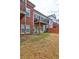Exterior shot of back of home and backyard with a deck, small patio and grass at 5883 Brookside Oak Cir, Norcross, GA 30093