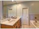 This bathroom features a vanity with double sinks and a jacuzzi bathtub at 5883 Brookside Oak Cir, Norcross, GA 30093
