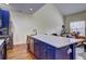 Bright kitchen with a large island featuring a marble countertop and stainless steel appliances at 5883 Brookside Oak Cir, Norcross, GA 30093