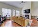 Living room featuring a fireplace, hardwood floors, lots of windows, and an open concept at 5883 Brookside Oak Cir, Norcross, GA 30093