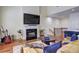 Open floor plan with a fireplace, TV, breakfast bar, and hardwood floors at 5883 Brookside Oak Cir, Norcross, GA 30093