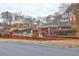 Community pool surrounded by brick walls, hedges, and mature trees, located near townhomes at 5883 Brookside Oak Cir, Norcross, GA 30093