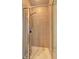 Tiled walk-in shower featuring a glass door, handheld shower head, and built in shelving at 5883 Brookside Oak Cir, Norcross, GA 30093