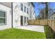 Backyard featuring a well-maintained lawn and a private patio area enclosed by a wooden fence at 662 S Grand Nw Ave, Atlanta, GA 30318
