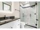 Modern bathroom featuring sleek vanity, a glass-enclosed shower, and black accents at 662 S Grand Nw Ave, Atlanta, GA 30318