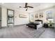 Bedroom featuring a ceiling fan, stylish decor, and access to a bathroom at 662 S Grand Nw Ave, Atlanta, GA 30318