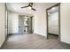 Spacious bedroom with hardwood floors, ceiling fan, ensuite bathroom, and walk-in closet at 662 S Grand Nw Ave, Atlanta, GA 30318