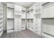 Walk-in closet with custom shelving, drawers, and rods for optimal storage and organization at 662 S Grand Nw Ave, Atlanta, GA 30318