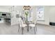 Dining area with hardwood floors, modern lighting, and open view to the kitchen at 662 S Grand Nw Ave, Atlanta, GA 30318