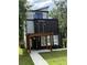 Modern three-story home featuring a balcony on the top floor with sleek architectural design at 662 S Grand Nw Ave, Atlanta, GA 30318