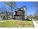 Attractive three-story modern home with balconies, a well-manicured lawn, and mature trees at 662 S Grand Nw Ave, Atlanta, GA 30318
