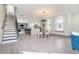 Bright living space with staircase, modern kitchen, dining area, and hardwood floors at 662 S Grand Nw Ave, Atlanta, GA 30318