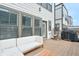 Relax on this deck featuring a comfortable couch, egg chair, and grill, perfect for outdoor entertaining at 2032 Holtz Ln, Atlanta, GA 30318
