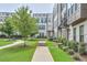 Exterior of townhomes with sidewalks, manicured lawns, and bench for enjoying the outdoors at 2032 Holtz Ln, Atlanta, GA 30318