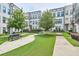 Exterior view of townhomes featuring sidewalks, bench, and meticulous landscaping at 2032 Holtz Ln, Atlanta, GA 30318