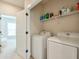 Convenient laundry room with modern appliances and built-in shelving for organized storage at 2032 Holtz Ln, Atlanta, GA 30318