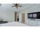 Spacious main bedroom with a ceiling fan, large TV, and ensuite bath at 2032 Holtz Ln, Atlanta, GA 30318