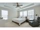Bright main bedroom featuring a tray ceiling, ceiling fan, and large windows providing ample natural light at 2032 Holtz Ln, Atlanta, GA 30318