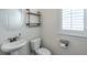 This powder room features a modern sink, shelving with industrial accents, and plantation shutters at 2032 Holtz Ln, Atlanta, GA 30318