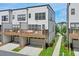 Shot of a rear exterior featuring a private deck above a garage, and a well manicured lawn at 2032 Holtz Ln, Atlanta, GA 30318