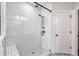 Beautifully tiled glass walk-in shower features dual shower heads and integrated seating at 2032 Holtz Ln, Atlanta, GA 30318