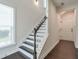 A modern staircase featuring dark wood floors, white risers and a white banister at 2032 Holtz Ln, Atlanta, GA 30318