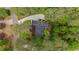 Aerial shot of a well-kept home with a dark roof, surrounded by green trees and bushes on a neatly landscaped property at 11165 Bentley Chase Dr, Johns Creek, GA 30097