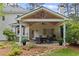 Exterior view of covered patio and stone fire pit in backyard at 11165 Bentley Chase Dr, Johns Creek, GA 30097