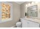 Elegant bathroom vanity with marble countertops and a large window at 11165 Bentley Chase Dr, Johns Creek, GA 30097