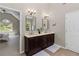 Primary bathroom boasts double vanity, dark cabinets, and access to the bedroom at 11165 Bentley Chase Dr, Johns Creek, GA 30097