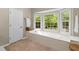 Bright bathroom featuring a soaking tub under a window and a tiled floor at 11165 Bentley Chase Dr, Johns Creek, GA 30097