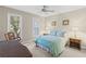 Comfortable bedroom with neutral walls, ceiling fan, and lots of natural light from windows at 11165 Bentley Chase Dr, Johns Creek, GA 30097