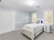 Bright bedroom featuring carpet, a single bed, closet, and a small dresser at 11165 Bentley Chase Dr, Johns Creek, GA 30097