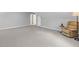 Expansive bonus room with neutral paint and an accent chair at 11165 Bentley Chase Dr, Johns Creek, GA 30097