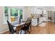 Breakfast nook with table and chairs, and a view of the kitchen with stainless appliances at 11165 Bentley Chase Dr, Johns Creek, GA 30097