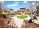 Picturesque community park with a circular lawn, rock garden and walkways that provides a serene outdoor gathering place at 11165 Bentley Chase Dr, Johns Creek, GA 30097