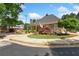 Community clubhouse with stone accents, landscaping, and sidewalk at 11165 Bentley Chase Dr, Johns Creek, GA 30097