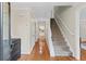 Spacious foyer with hardwood floors, a staircase, and natural light creating a warm and inviting entry at 11165 Bentley Chase Dr, Johns Creek, GA 30097