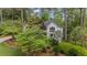 A lovely two-story home boasts lush landscaping, mature trees, and an elegant exterior, offering a serene and inviting appeal at 11165 Bentley Chase Dr, Johns Creek, GA 30097