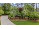 A well-maintained home with mature trees and professional landscaping, showcasing its inviting curb appeal at 11165 Bentley Chase Dr, Johns Creek, GA 30097