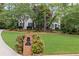 Charming home featuring a well-manicured lawn, mature trees, and brick mailbox, adding to its inviting curb appeal at 11165 Bentley Chase Dr, Johns Creek, GA 30097