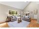 Sunlit living room with hardwood floors and two comfortable sofas at 11165 Bentley Chase Dr, Johns Creek, GA 30097