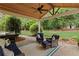 Outdoor patio with ceiling fan, grill, and comfortable seating area at 11165 Bentley Chase Dr, Johns Creek, GA 30097