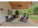 Covered outdoor patio with fan, grill and wicker furniture seating at 11165 Bentley Chase Dr, Johns Creek, GA 30097