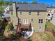 A well-maintained backyard with a wooden deck, patio, and stairs leading to a lush green space at 213 Roseman Way, Woodstock, GA 30188