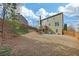 Spacious backyard with a wooden fence, green grass, and a deck, perfect for outdoor enjoyment at 213 Roseman Way, Woodstock, GA 30188