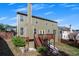A view of the house's rear, featuring a deck, lush greenery, and a well-maintained yard at 213 Roseman Way, Woodstock, GA 30188
